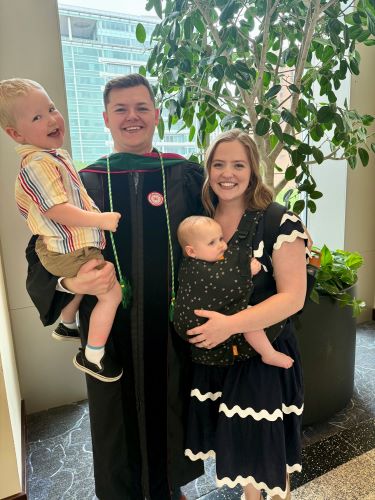 Gabe Kramer at Medical School Graduation with his wife, Clara, and children Henry and Ruth.
